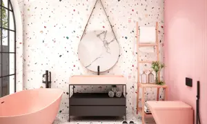 Bagno moderno con vasca rosa, lavabo, specchio rotondo e un vivace **pavimento in graniglia di marmo** multicolore.