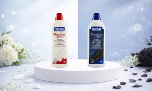 Due flaconi di detersivo Nuncas, uno bianco e uno nero, per risolvere il problema che la lavatrice non lava bene i bianchi.