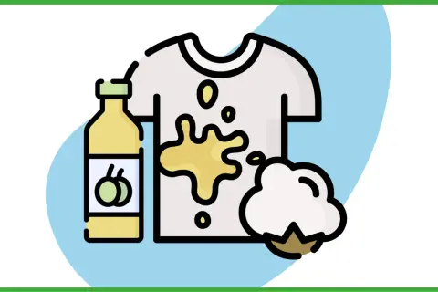Come togliere macchie di olio dopo lavaggio: una bottiglia di olio, una maglietta macchiata e un batuffolo di cotone.